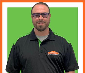 Josh, Male employee with SERVPRO uniform in front of white wall