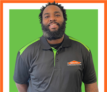 servpro employee against a green background